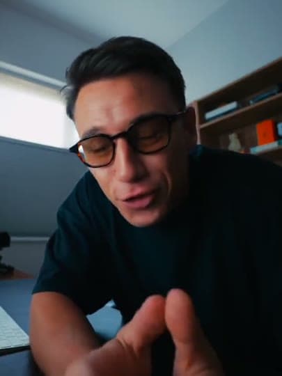 A creator speaking to camera in a home studio